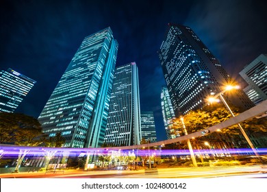 Asia Business concept for real estate and corporate construction - looking up night view in road intersection of shinjuku, the silhouettes of skyscrapers reflect twilight sky in Tokyo, Japan