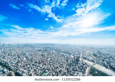 Asia Business concept for real estate and corporate construction - panoramic modern city urban skyline bird eye aerial view under sun & blue sky in Tokyo, Japan - Powered by Shutterstock