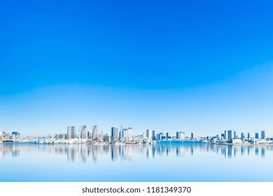 Asia Business Concept For Real Estate And Corporate Construction - Panoramic City Skyline Aerial View Of Tokyo Bay With Mirror Reflection Under Blue Sky In Odaiba, Tokyo, Japan