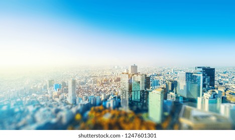 Asia Business Concept For Real Estate And Corporate Construction - Panoramic City Skyline Aerial View Under Blue Sky & Sun In Shinjuku Tokyo, Japan With Tilt Shift, Miniature, Blur Effect