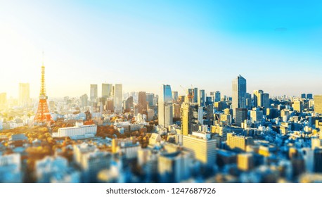 Asia Business Concept For Real Estate And Corporate Construction - Panoramic City Skyline Aerial View With Tokyo Tower Under Blue Sky & Sun In Tokyo, Japan With Tilt Shift, Miniature, Blur Effect