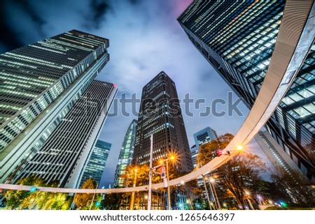 Asia Business concept for real estate and corporate construction - looking up night view in road intersection of shinjuku, the skyscrapers reflect twilight sky in Tokyo, Japan
