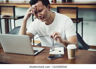 Asia Casual Man Cover Face With Hand Upset From Work In Front Of Laptop Computer In Coffee Shop,stress Emotion Concept,work Outside Office,work At Home