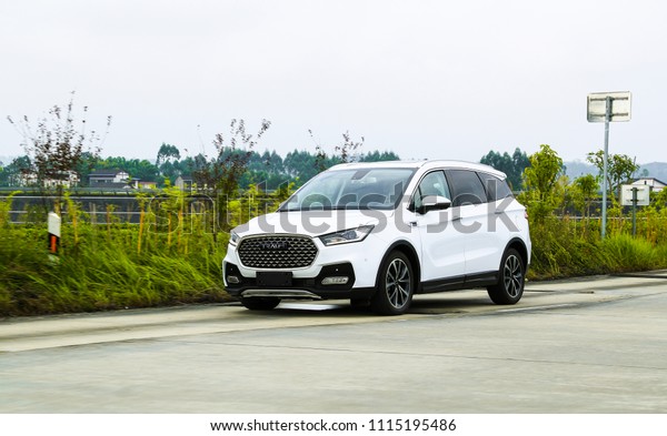 Asia, China, Chongqing - June 25, 2017: Tester of\
Junma Motor is testing the new white suv car in Chongqing\'s\
production base