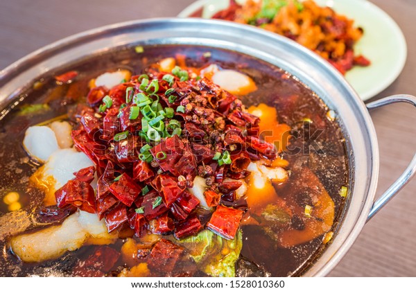 Asia, China food.\
Szechuan water boiled spicy fresh fish hotpot steamboat. Fried\
Chicken side dish.
