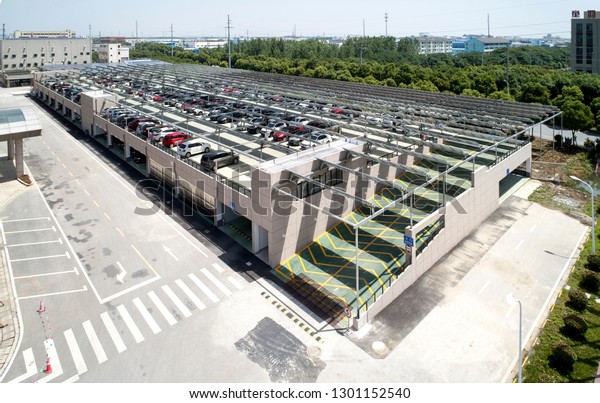 Asia, China, Jiangsu, May 23, 2018: In the\
parking lot of China’s Jiangsu Zhongli Tenghui PV Enterprise, there\
are many employees’ cars parked in\
it.