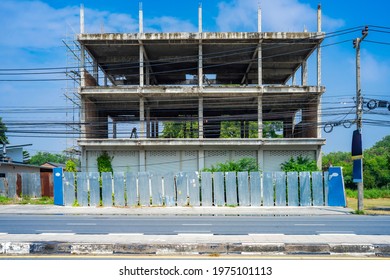 Asia Commercial building in underconstruction process beside the road with Galvanized sheet facade and fence around it. Thailand.