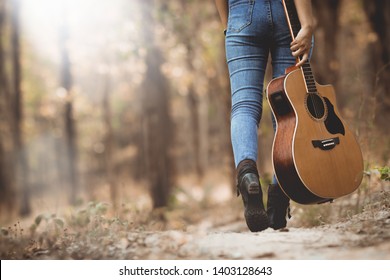 Asia country music woman playing the guitar in the forest with relax and happy in free time,use for web cover design,background.