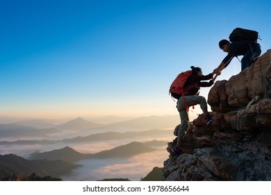 Asia Couple Hiking Help Each Other On Mountains View . Teamwork