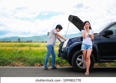 Asia Couple Traveler Have A Problem About Car.beautiful Lady Calling To Insurance To Help And Fix Her Broken Car Stop Near The Road During Her Travel On Vacation.