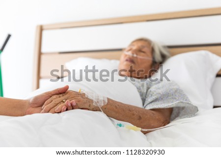 Caregiver checking blood pressure to a senior woman