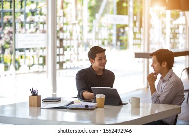 Asia Gay Couples Work Freelance Together In An Office Using Tablet And Computers