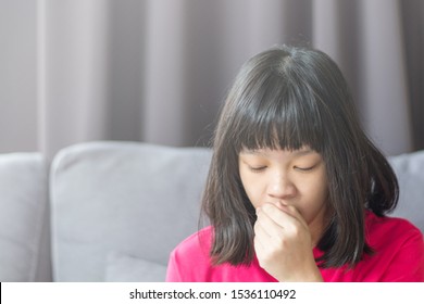 Asia Girl Child Coughing As Allergy From Air Pollution. Asian Kid Use Hand To Cover Her Mouth To Reduce The Number Of Virus Germs  To Spread  When Cougn From Illness.