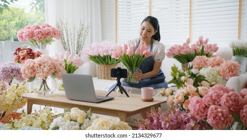 Asia Girl Vlogger Influencer Or SME Owner People Smile Work On Home Video Camera Selfie Shoot Filming For Live Sell Show Happy Talk On Mobile VoIP App. Remote Sale Product At Modern Florist Gift Shop.