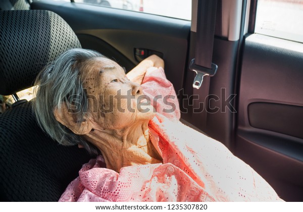 Asia Grandmother sleep in\
the car.