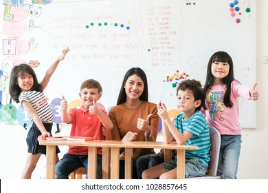 Asia Kids And Teacher Learning English In Classroom At School, Asian English Teacher And Diverse Children Classroom, Diverse Kids At  Pre School Class, Kindergarten, Education Concept