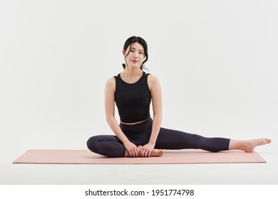 Asia Korean Gorgeous Young Woman.  Practicing Yoga Indoor. Beautiful Girl Practice Pose In Class. Calmness And Relax, Female Happiness.Horizontal, White Background