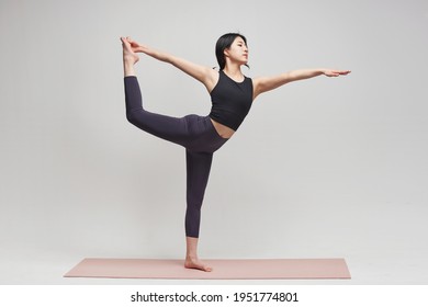 Asia korean gorgeous young woman.  practicing yoga indoor. Beautiful girl practice pose in class. Calmness and relax, female happiness.Horizontal, white background - Powered by Shutterstock