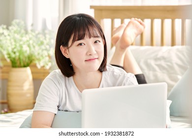 asia, korean woman, laptop, on the bed, watching   laptop or smart phone, selfie   
