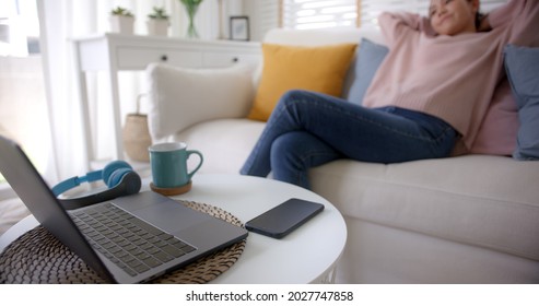 Asia Lady People Sitting Easy Hand Behind Head Work At Sofa Cozy Home Lying Down Close Cellphone With Calm Day Dream. Tired Life Time To Log Out, Leave Health Care Issue, Stop Turn Off Social Media.