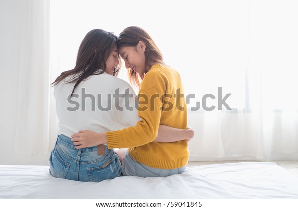 Asia Lesbian Lgbt Couple Hug And Sitting On Bed Near White Window With