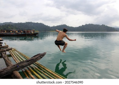 The Asia Man Jump Show Back Skin From Wood To The River At Thailand