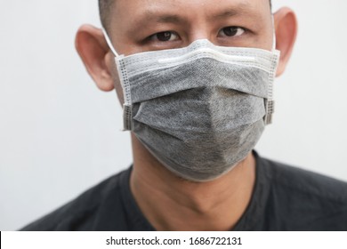 Asia Man Wearing Activated Carbon Face Mask On White Background