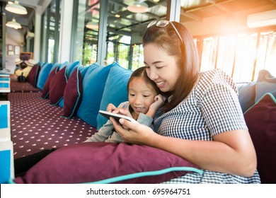 Asia Mother And Daughter Or Kid Enjoy Playing Smartphone, Happy Family Using Mobile Phone