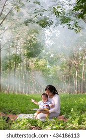 Asia Mother Reading Book For Her Baby