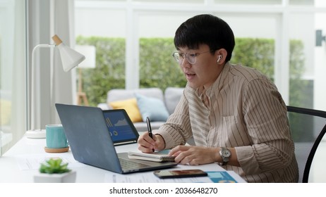 Asia People Glasses Chinese Male Busy Talk Discuss On Desk At Home In Employee Digital Reskill Upskill Class, Social Distance College Learner, Staff Worker Job Self Training, Study MBA On VoIP Webcam.