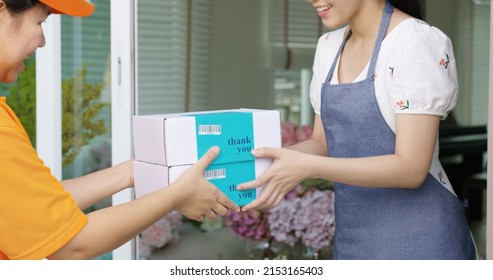 Asia people SME owner carrying parcel carton box on hand send product on site picking up at home drop off fulfilment dropshipping sell in same day post mail service work at gift shop store workspace.