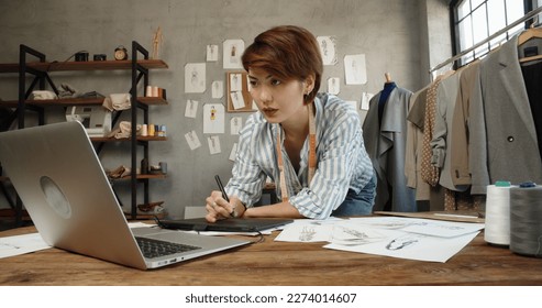 Asia people SME owner or retail fabric craft store work in artist studio home office on desk busy learn online study art class on laptop in digital dress color screen app write job idea skill on web. - Powered by Shutterstock