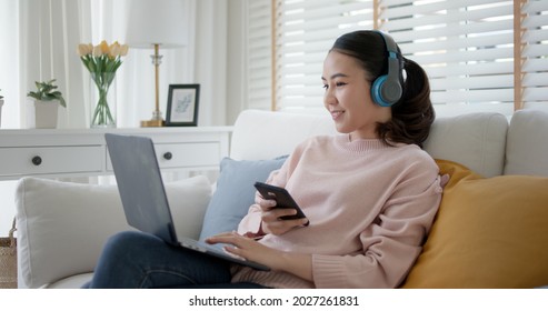 Asia People Teen Enjoy Learn MBA Class Study At Home Relax Sit Sofa Work Read Text In Social Media, Scroll Laptop Search App, Watch Wifi Movie. Blogger Girl Smile Happy Life Listen Music Multi Task.