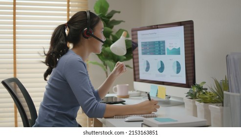 Asia people young casual woman remote work at desk home phone call talk study learn MBA online class. SEO sale plan report data chart graph on desktop PC screen reskill upskill career job workforce. - Powered by Shutterstock