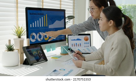 Asia people young happy female busy worker small team sale report talk consult multiple screen notebook at home office learn online reskill upskill, smart marketer startup cowork idea design career. - Powered by Shutterstock