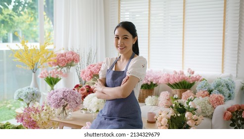 Asia people young woman SME owner happy smile arms crossed look camera enjoy open flower shop work at home office workspace. Loan money banking for online store seller. Girl power pride in sale order.