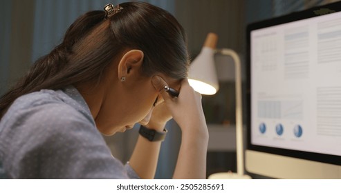 Asia people young woman study hard overnight brownout bored remote learn online read data tired sitting head in hands at home office desk workplace think worry in job tough stress workforce issue. - Powered by Shutterstock