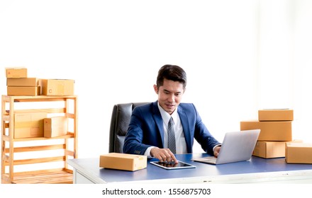 Asia Postman In Suit Is Checking Name,address On Boxes Carefully Before Deliver To Customer At Office,Professionals Engaged In Cargo Transportation,Delivery Man Confirm The Order To Online Customer.