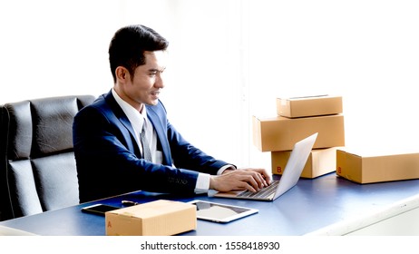 Asia Postman In Suit Is Checking Name,address On Boxes Carefully Before Deliver To Customer At Office,Professionals Engaged In Cargo Transportation,Delivery Man Confirm The Order To Online Customer.