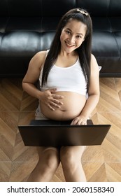 Asia Pregnant Mother Use A Computer For Online Shopping On Holiday.The Idea Of Buying Baby Supplies
