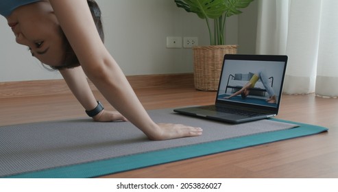 Asia Serene People Enjoy Teach Pilates Zen Online Hobby Class On Laptop. Woman Student Remote Learn Body Deep Relax Pose Course On Mat At Home Indoor Happy Life Watch Live Stream Sports Media Video.