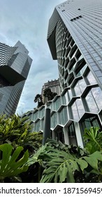 ASIA, SINGAPORE - 11 December 2020 : Modern Unique Exterior Design High Scrapper Office Cum Hotel And Residential Apartments From Low Angle View Looking Up, In City CBD Financial District.