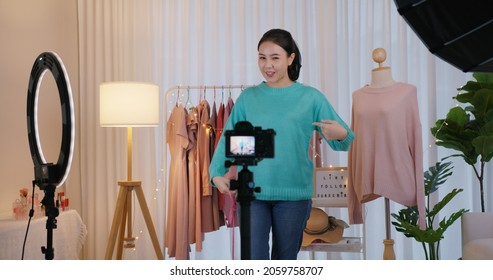 Asia SME owner or seller woman micro influencer record live talk video camera at home studio. Happy youtuber fun speak review hobby in media. Vlogger selfie shoot enjoy work smile in reel story app.