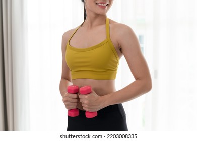 Asia Sport Woman Holding Dumbbell In Living Room At Home	