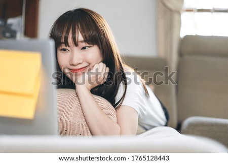 Asia student study online stay at home for new normal from virus concept. Asian teenager woman learning via internet technology with laptop. Living room background with window light.