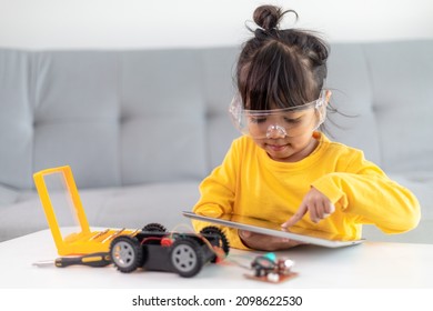 Asia students learn at home in coding robot cars and electronic board cables in STEM, STEAM, mathematics engineering science technology computer code in robotics for kids concept.