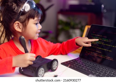 Asia students learn at home in coding robot cars and electronic board cables in STEM, STEAM, mathematics engineering science technology computer code in robotics for kids concept.