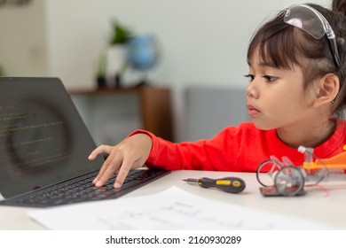 Asia students learn at home in coding robot cars and electronic board cables in STEM, STEAM, mathematics engineering science technology computer code in robotics for kids concept.