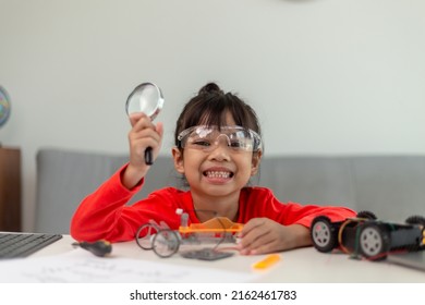 Asia students learn at home in coding robot cars and electronic board cables in STEM, STEAM, mathematics engineering science technology computer code in robotics for kids concept.