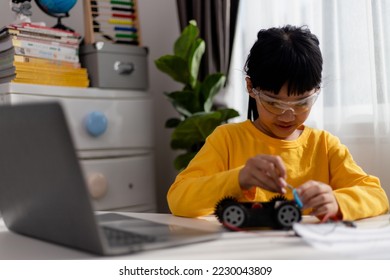 Asia students learn at home in coding robot cars and electronic board cables in STEM, STEAM, mathematics engineering science technology computer code in robotics for kids concept.